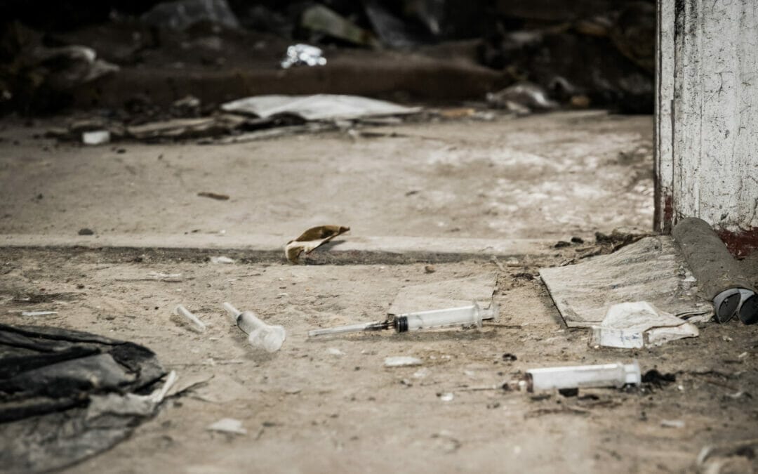 Abandoned place with drug needles on the floor